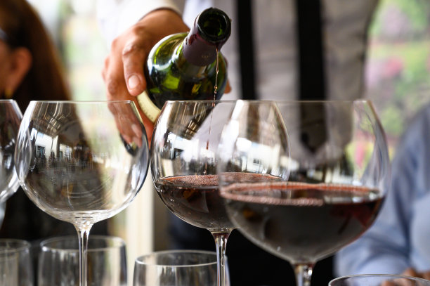 穿制服的服务员在餐厅里为客人斟酒。图片下载