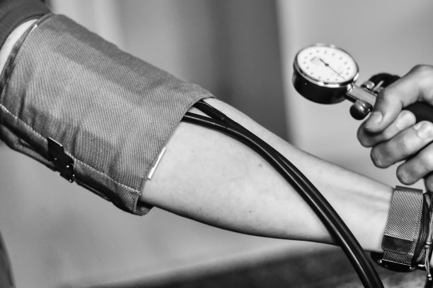 医生在检查他的病人和他的血压图片下载