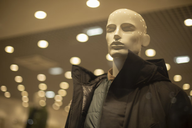 穿着夹克的男模特。商店里的外套。男装店的橱窗。图片下载