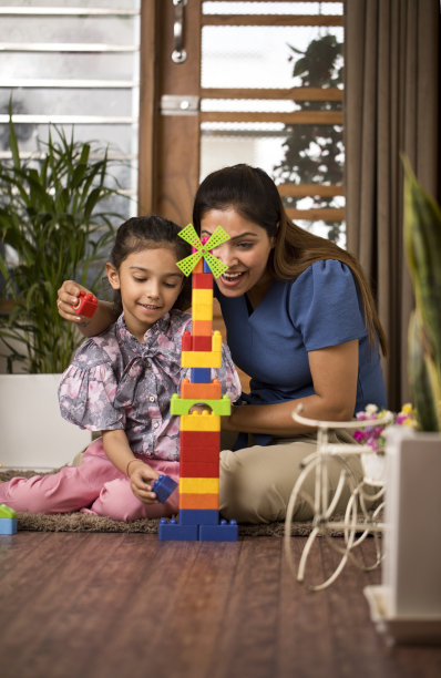 快乐的母女在家里玩积木图片下载