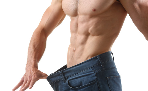 强壮的男人肌肉和六块腹肌，苗条的身材，完美的身材，大裤子图片下载