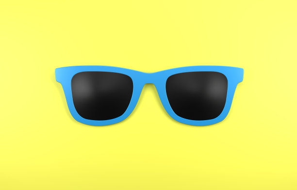 蓝色太阳镜在黄色背景图片下载