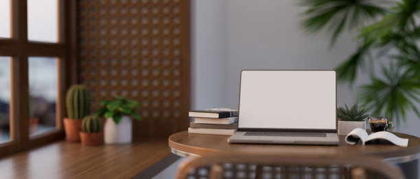 现代室内的咖啡店休息区，木制桌子上放着笔记本电脑模型。图片下载