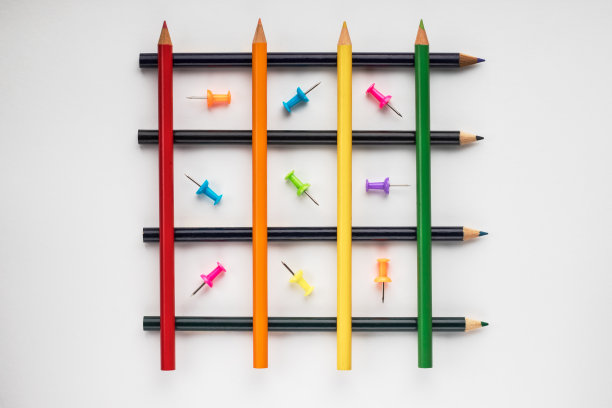 彩色铅笔以格子的形式排列成行。细胞包含彩色图钉。文具、概念图片下载