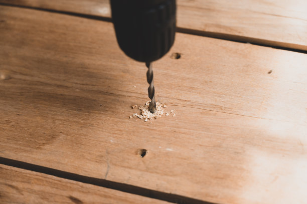 电钻:用电钻在木板上钻孔的过程手持电动工具。特写镜头。有选择性的重点。没有人。图片下载