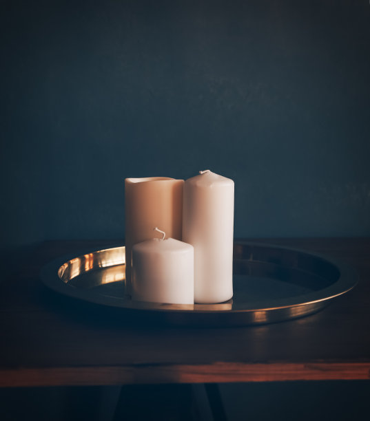 三根装饰蜡烛放在内部的托盘上。图片下载