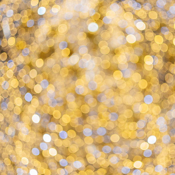 背景与散景图案在金色的色调。光学散焦效应。节日的图片图片下载