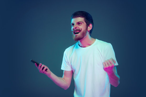 肖像兴奋，惊讶的男子叫喊孤立在深蓝色工作室背景，人类情感的概念，面部表情，销售，广告，时尚和美容图片下载