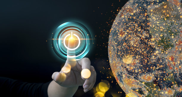 手指按下电源按钮能量地球在夜间背景。地球日。图片下载