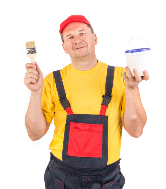工人拿着油漆桶和刷子。图片下载
