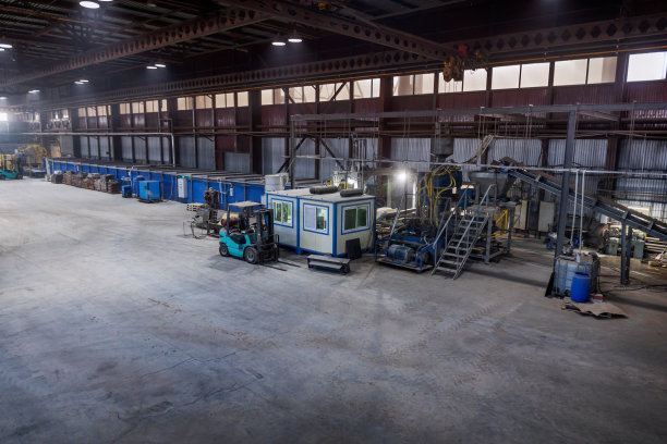 省小生产建筑用砖。工业厂房，水泥地面和人工照明。图片下载