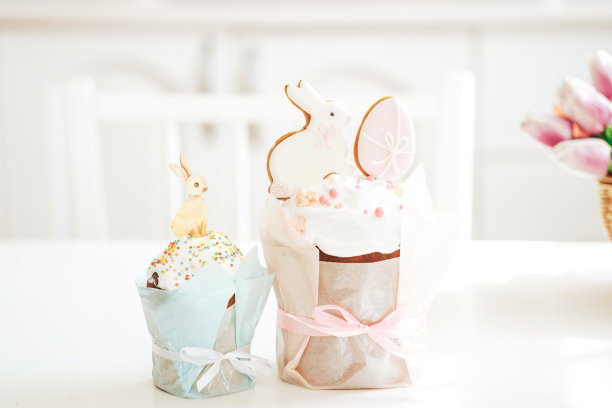 兔子形状的饼干和鸡蛋蛋糕放在白色的桌子上图片下载