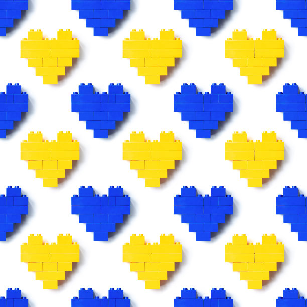心从乐高积木为背景，无缝图案从乐高塑料积木蓝色和黄色的颜色，形状的心从儿童建设。俯视图重复打印，玩具和游戏图片下载