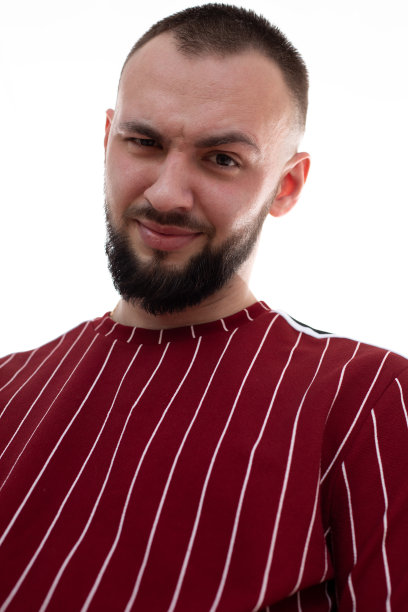 垂直图像不刮胡子微笑的男人的脸，鬼脸和看着相机，有鬃毛。提高眉毛具有讽刺意味的是图片下载