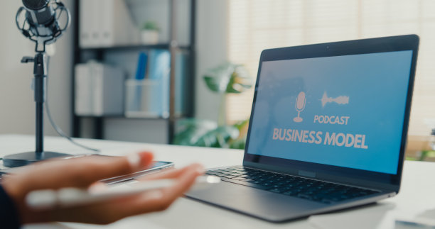 年轻的亚洲女商人录制和广播播客在她的笔记本电脑从工作室办公室。图片下载