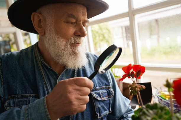 年迈的花商在自己的店里检查鲜花图片下载