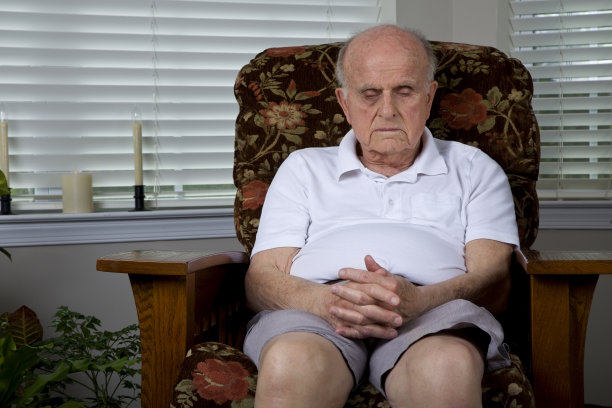 老人在家里舒适的椅子上闭着眼睛打盹图片下载