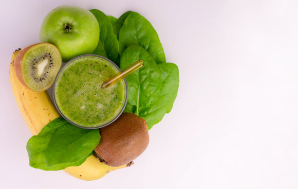 用猕猴桃，菠菜，香蕉做成的绿色奶昔，白色背景。副本的空间。图片下载