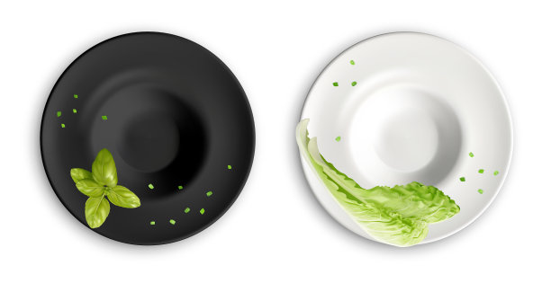 黑色和白色的空盘子里放着绿叶菜图片下载