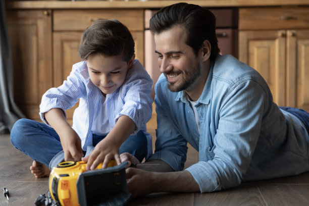 图为快乐的爸爸和小儿子在修理玩具车图片下载