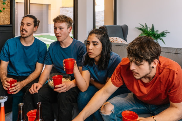 朋友们一起观看电视转播的体育比赛。看电影。青春吃喝。图片下载