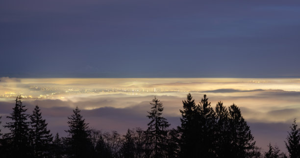 在冬季日落黄昏时，雾笼罩着现代城市。图片下载