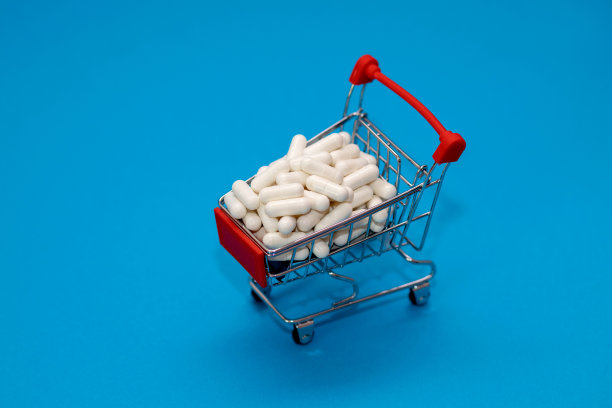 装满药品的小推车，蓝色背景上是一篮子药丸，医学概念图片下载