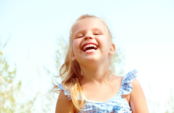 笑着蹒跚学步的漂亮女孩的肖像。快乐的童年和自由的理念图片下载