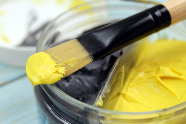 装在罐子里的双色面膜，用刷子涂抹。图片下载