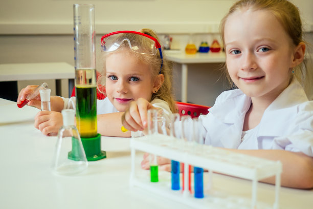 两个金发碧眼的化学家学校的孩子学生小女孩(女朋友姐妹)化学实验白袍教室科学图片下载