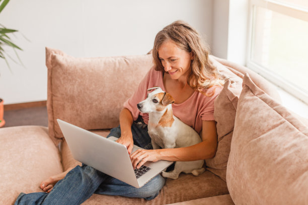快乐的女人使用银色笔记本电脑图片下载