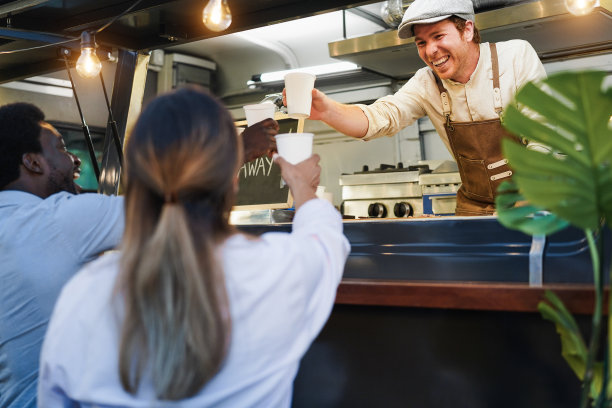 西班牙裔男子在餐车里提供外卖-专注于厨师的脸图片下载