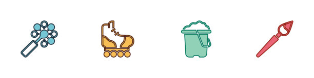 把拨浪鼓婴儿玩具溜冰鞋和沙子放在桶里图片下载