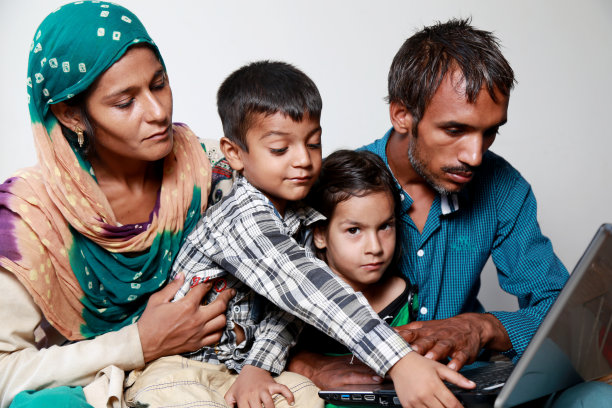 印度家庭在家里一起使用笔记本电脑图片下载