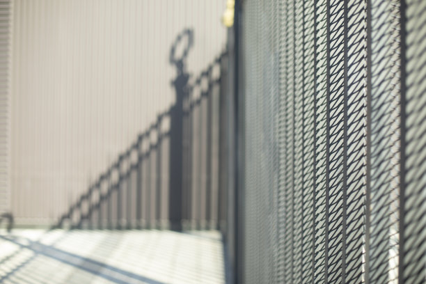 篱笆上街道。栅栏。领土上郊区的细节。图片下载