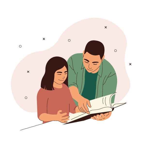 父亲和女儿坐在书桌前一起读书。图片下载