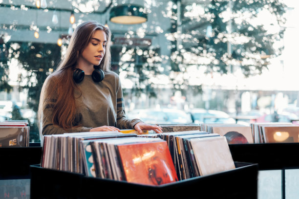 女人在唱片店里挑选黑胶唱片图片下载