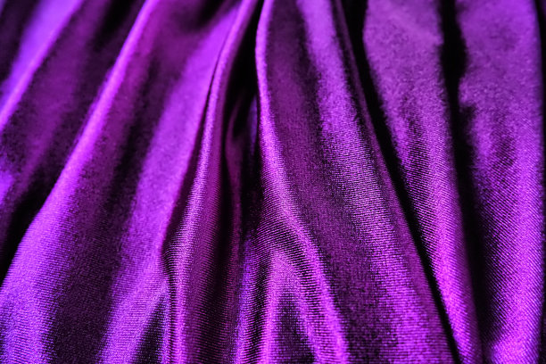 丝绒织物，类似丝绸纺织品的褶皱和美丽的波浪。窗帘上有紫色，粉色，品红色。晚礼服、家具、室内装饰、窗帘、室内装饰的缝纫材料图片下载