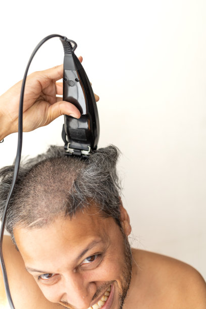 英俊的白发男子正在剪发。图片下载