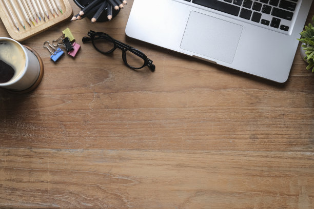 平板笔记本电脑眼镜，咖啡杯和用品在木制背景上的拷贝空间。图片下载