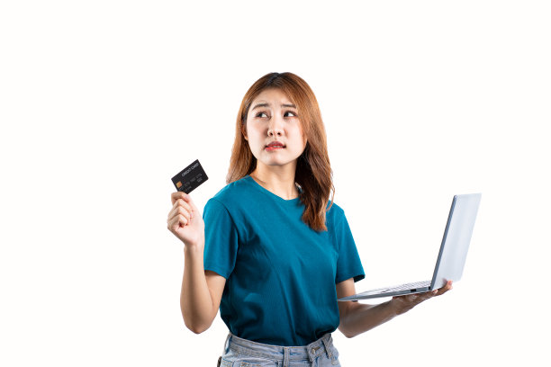 亚洲女性持有信用卡和白色背景的笔记本电脑，网上购物的概念。图片下载