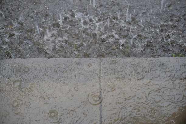 倾盆大雨溅落在地面和水泥平台上图片下载
