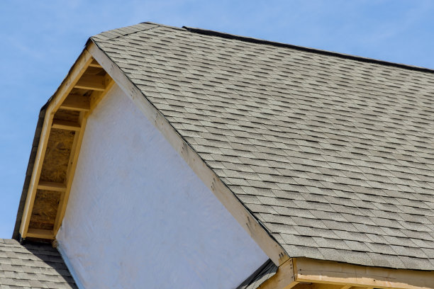 在建筑物的有盖角落用沥青瓦盖的新房子的屋顶防水图片下载