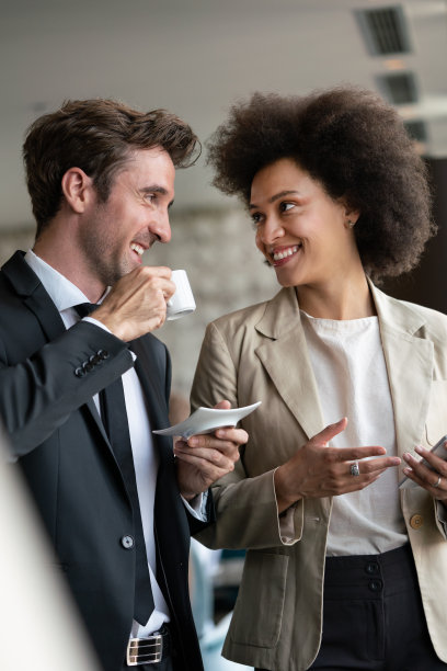 两个年轻的商人在餐馆成功地见面。图片下载