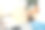 法国斗牛犬躺在枕头上看着男人腿上的笔记本电脑。图片下载