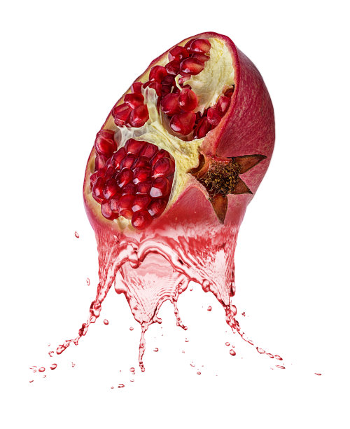 新鲜成熟的石榴、石榴汁。美味的红石榴果汁飞溅图片下载
