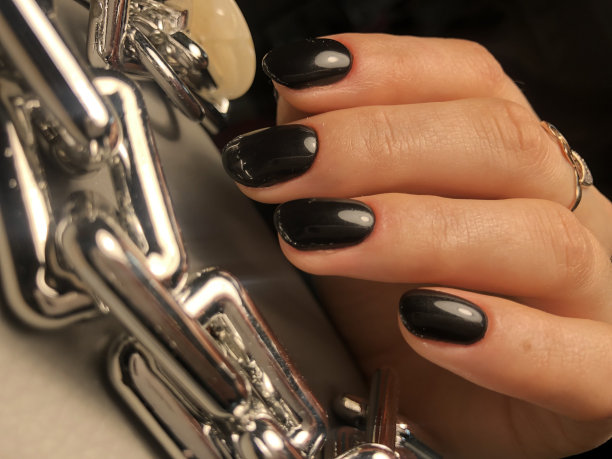 一个女人手上的黑色美甲图片下载