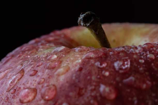 特写图片的苹果与水滴和黑色背景图片下载