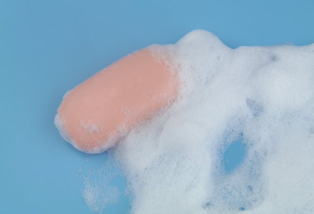 蓝色背景上有泡沫和肥皂。图片下载