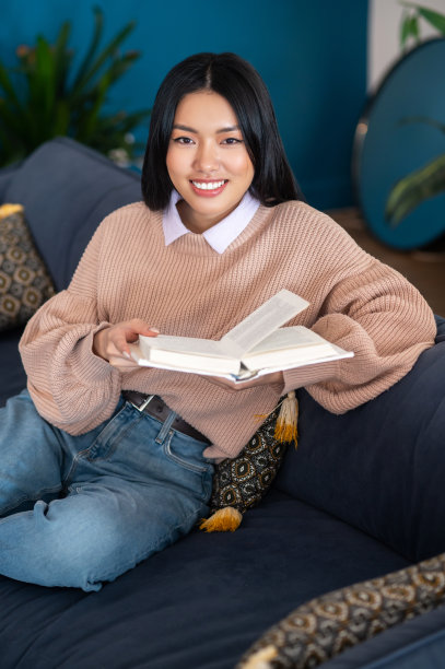 微笑可爱的亚洲女孩手里拿着一本书图片下载